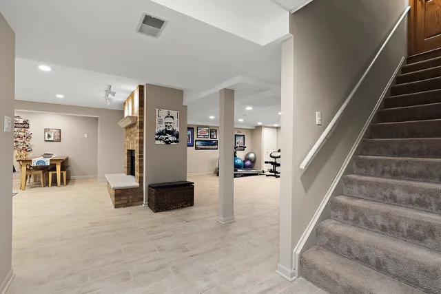 a living room with furniture a fireplace and kitchen view