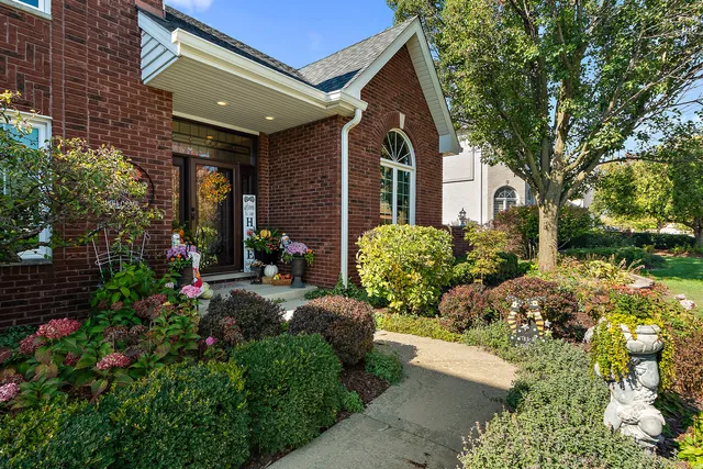 an aerial view of ocean and residential houses with outdoor space
