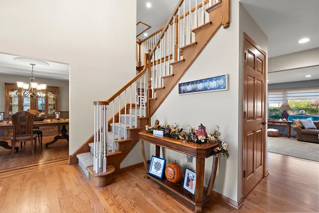 a view of a dining room with furniture wooden floor and chandelier