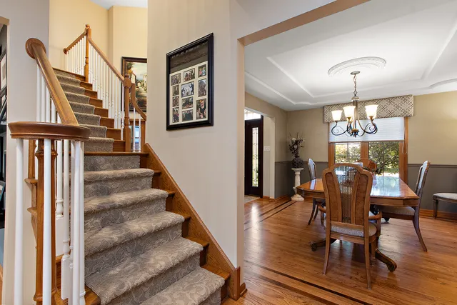 a view of a livingroom with furniture staircase and a kitchen