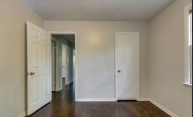 an empty room with wooden floor