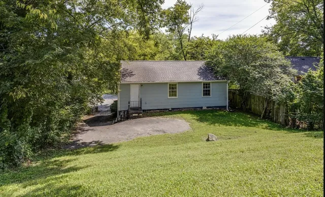a backyard of a house with yard and trampoline