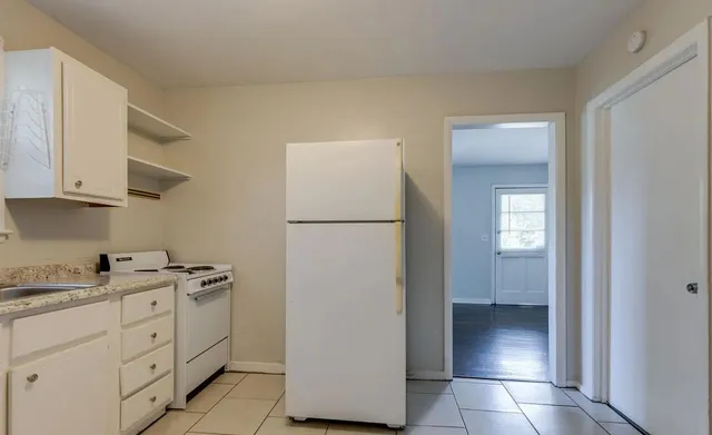 a kitchen with a refrigerator sink and cabinets