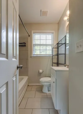 a bathroom with a toilet a sink and bathtub