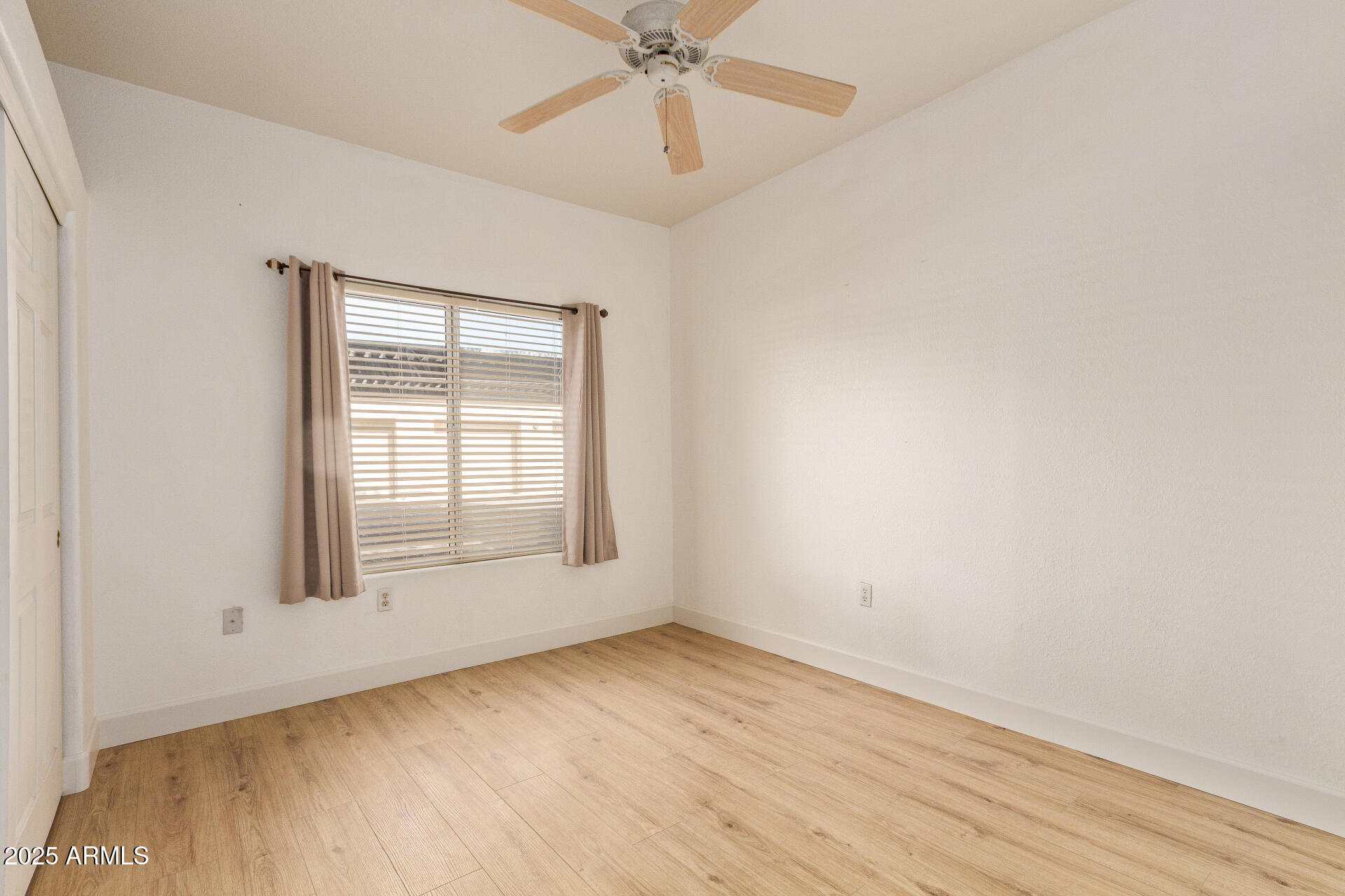 7101 West Beardsley Road, Unit 451 Glendale, AZ 85308 - Photo 14 of 26 an empty room with a window and a ceiling fan