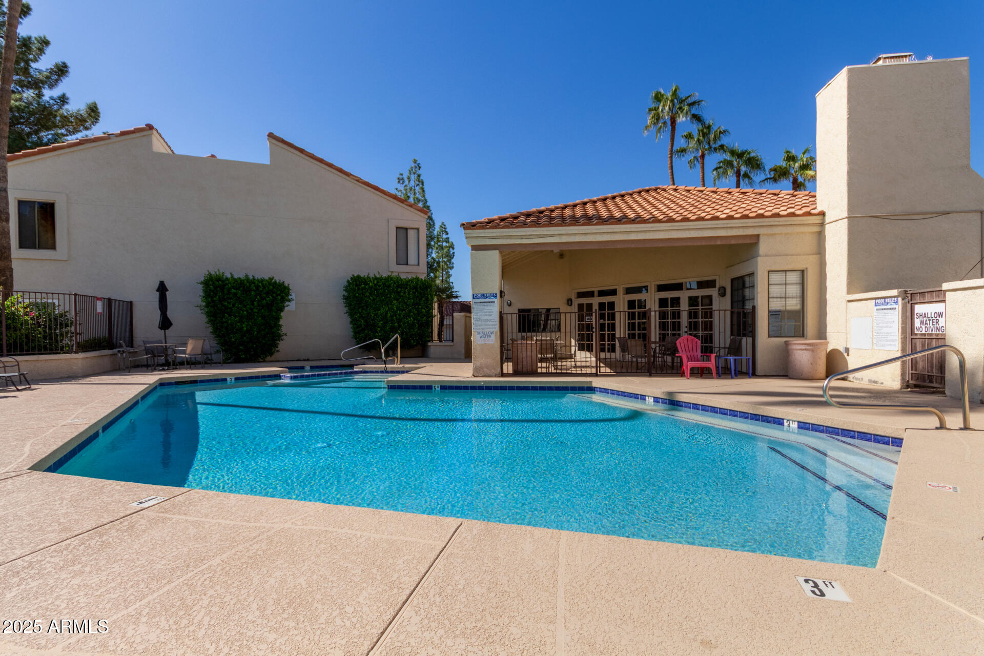 7101 West Beardsley Road, Unit 451 Glendale, AZ 85308 - Photo 24 of 26 a view of a house with swimming pool and a table and chairs