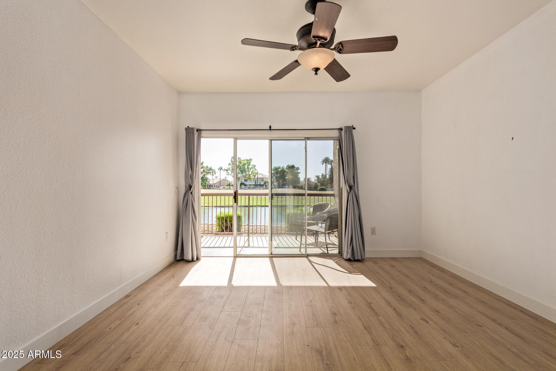 7101 West Beardsley Road, Unit 451 Glendale, AZ 85308 - Photo 3 of 26 wooden floor in an empty room with a window