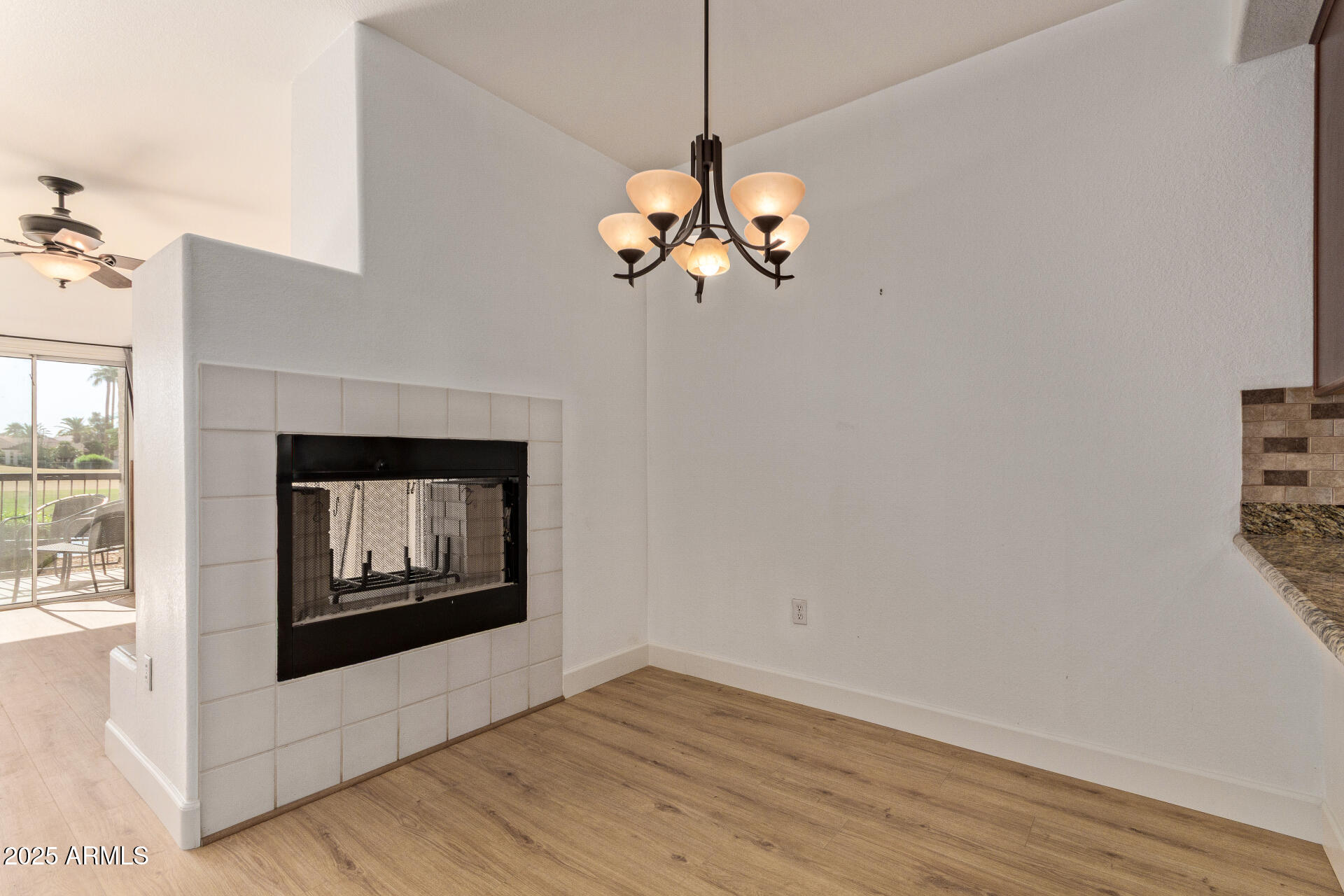 7101 West Beardsley Road, Unit 451 Glendale, AZ 85308 - Photo 7 of 26 a view of an empty room with wooden floor and a window