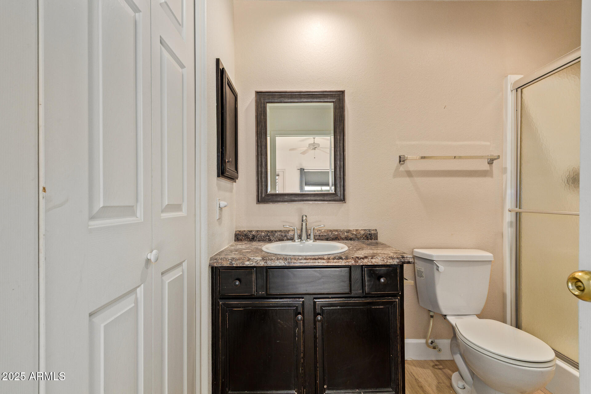 7101 West Beardsley Road, Unit 451 Glendale, AZ 85308 - Photo 10 of 26 a bathroom with a toilet sink and mirror