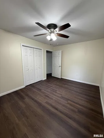 a view of an empty room and wooden floor