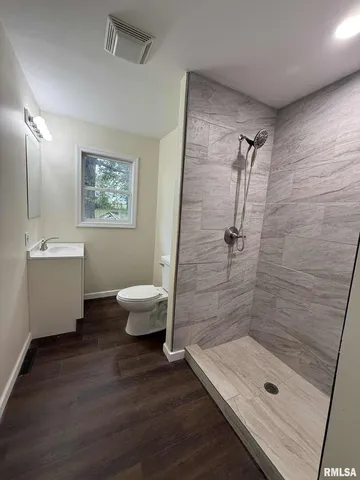 a bathroom with a shower curtain and a window