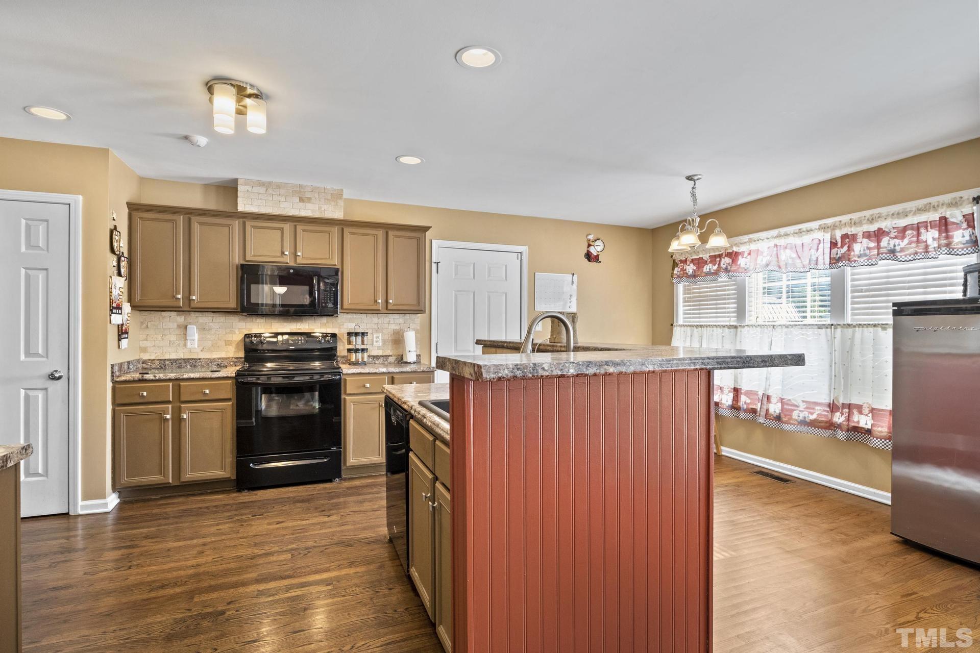 117 Mendel Drive Smithfield, NC 27577 - Photo 12 of 39 a kitchen with stainless steel appliances a refrigerator and a stove top oven