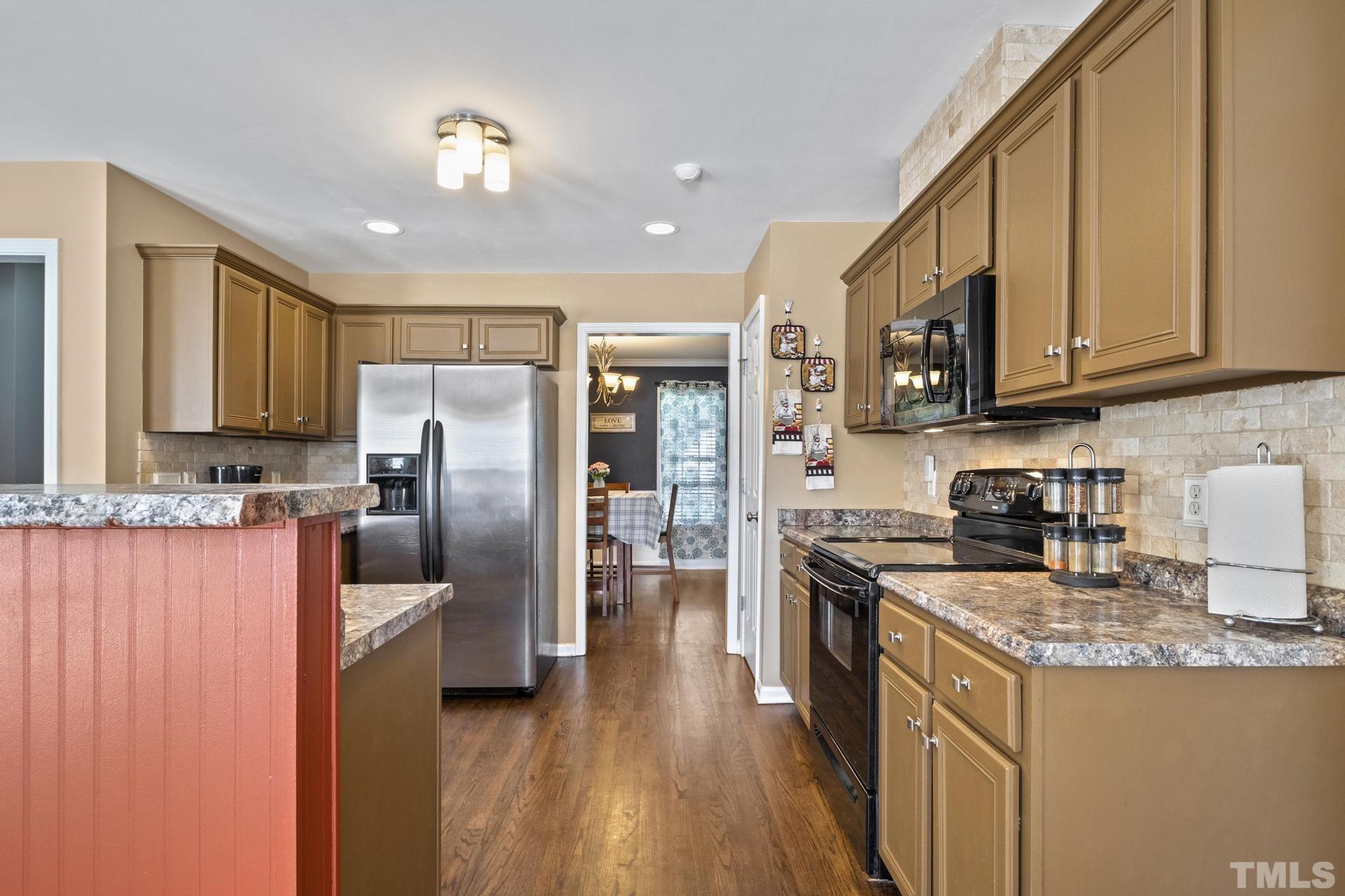 117 Mendel Drive Smithfield, NC 27577 - Photo 15 of 39 a kitchen with stainless steel appliances granite countertop a refrigerator a stove top oven a sink and dishwasher
