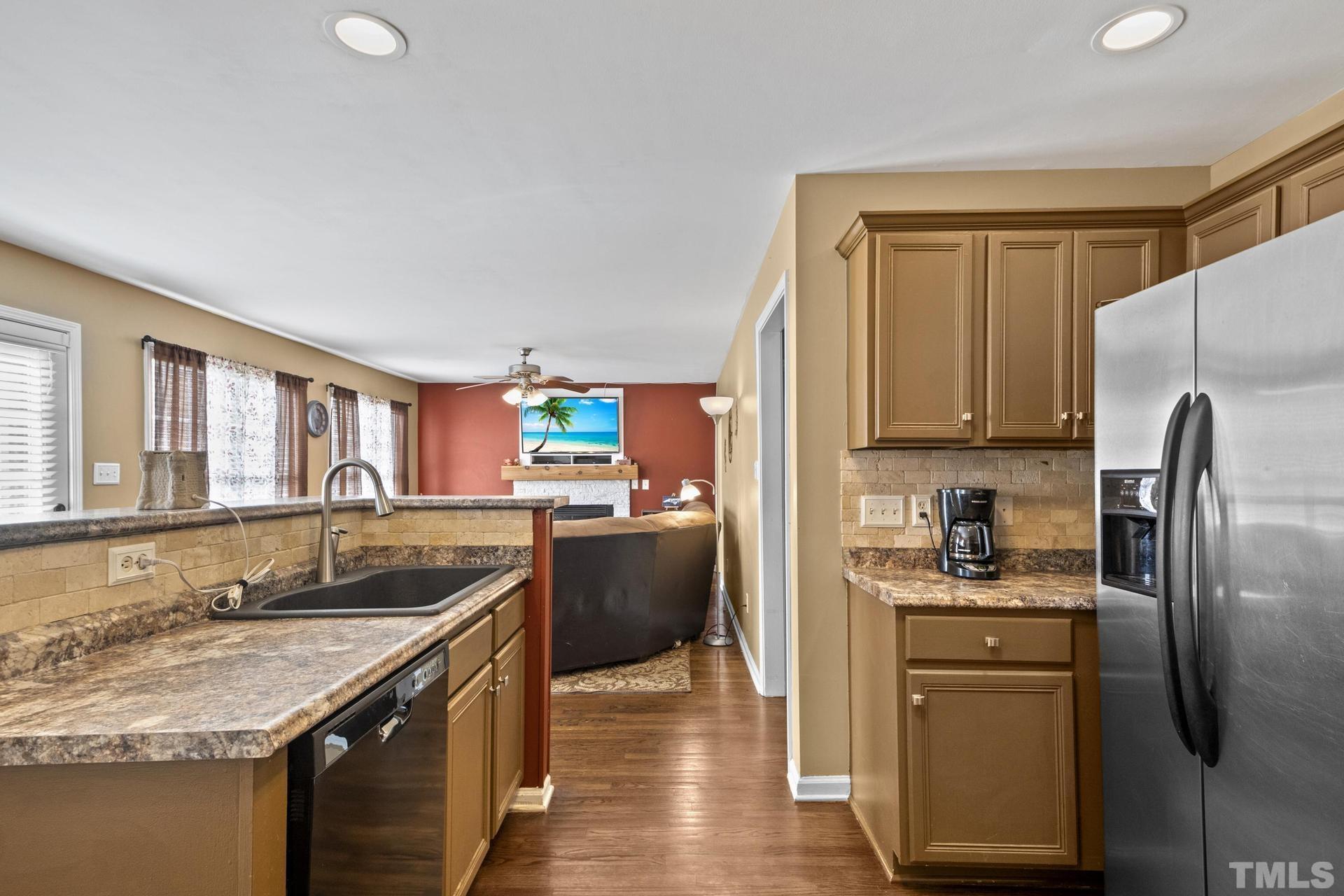 117 Mendel Drive Smithfield, NC 27577 - Photo 16 of 39 a kitchen with granite countertop a sink stove and refrigerator