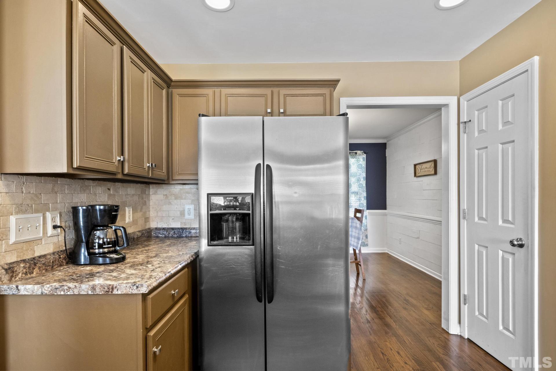 117 Mendel Drive Smithfield, NC 27577 - Photo 17 of 39 a kitchen with granite countertop a refrigerator and a sink