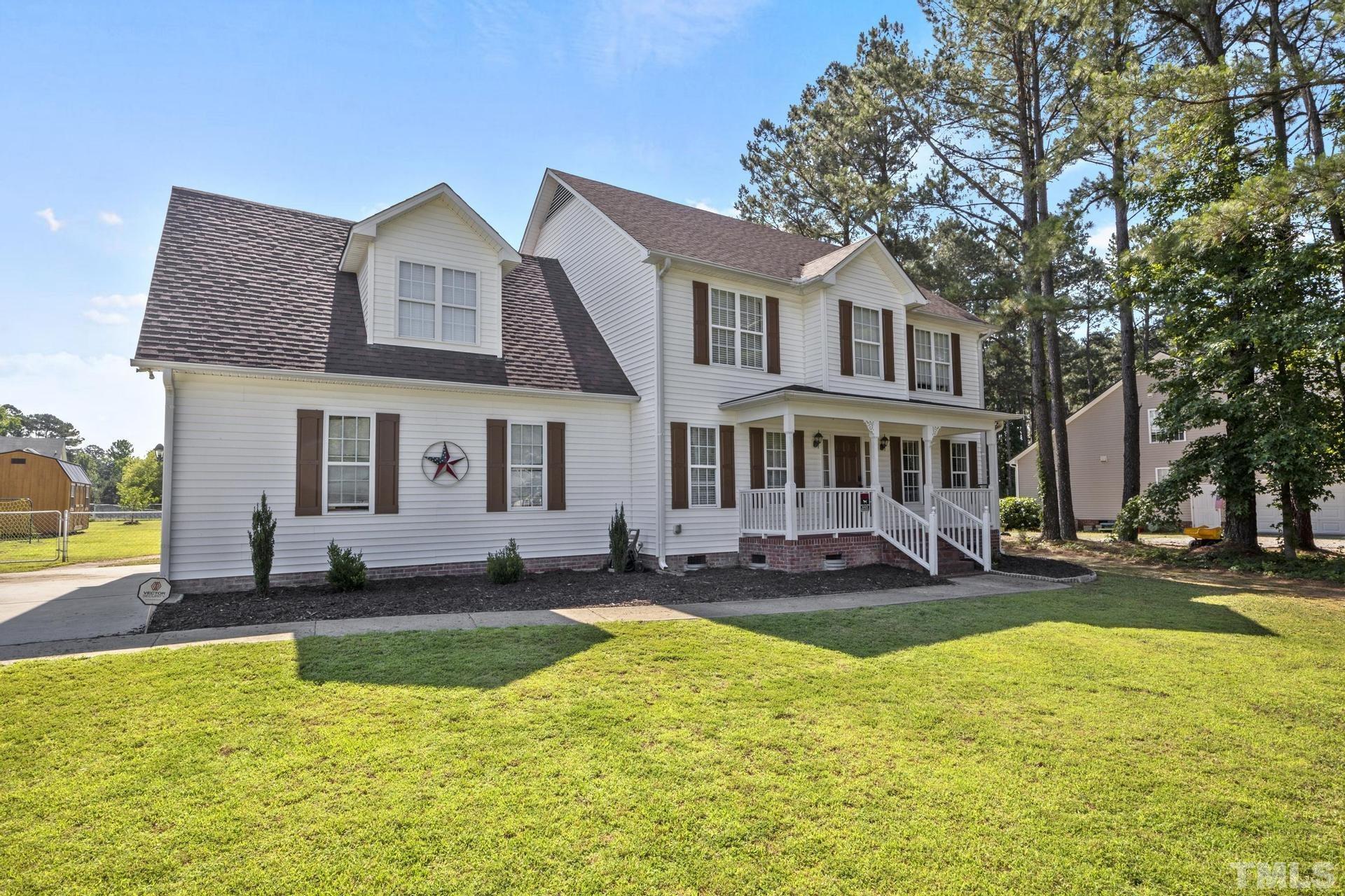 117 Mendel Drive Smithfield, NC 27577 - Photo 2 of 39 a front view of a house with swimming pool and yard
