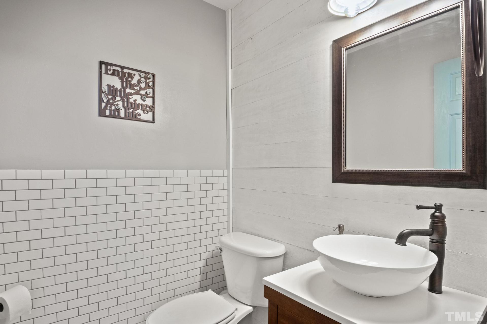 117 Mendel Drive Smithfield, NC 27577 - Photo 21 of 39 a bathroom with a toilet a sink and mirror