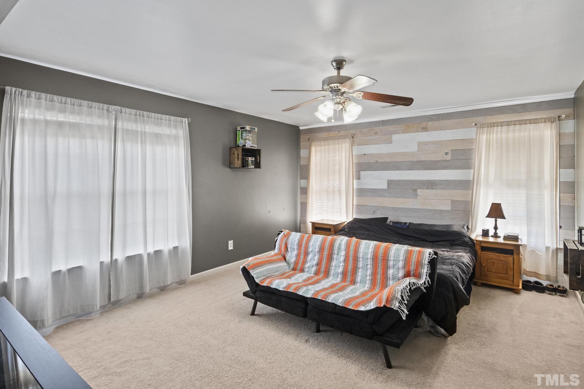 117 Mendel Drive Smithfield, NC 27577 - Photo 23 of 39 a bedroom with a bed and a chandelier