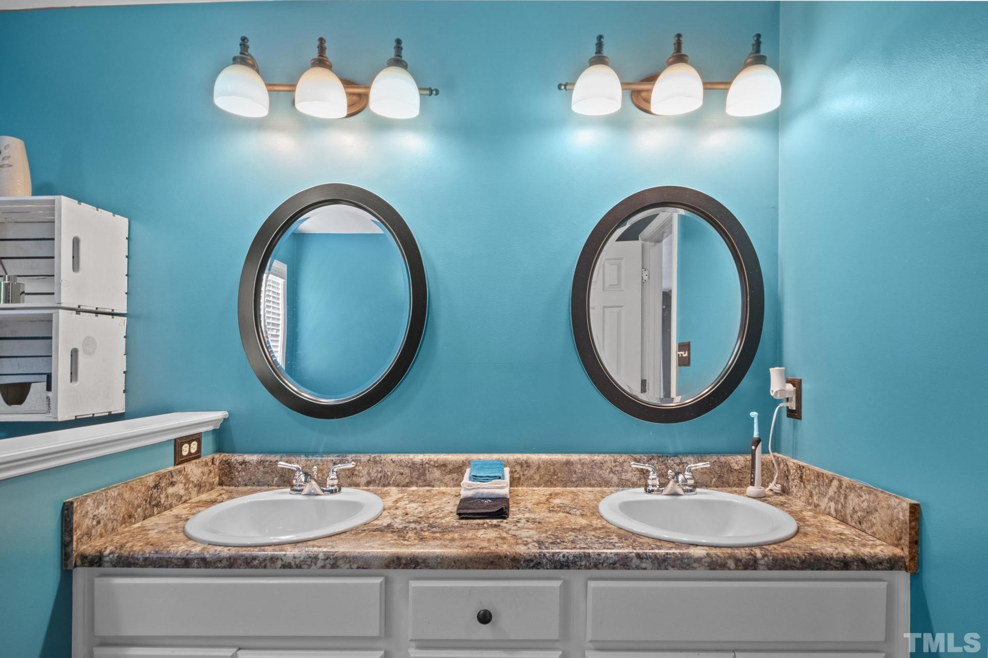 117 Mendel Drive Smithfield, NC 27577 - Photo 25 of 39 a bathroom with a granite countertop double vanity sink and a mirror