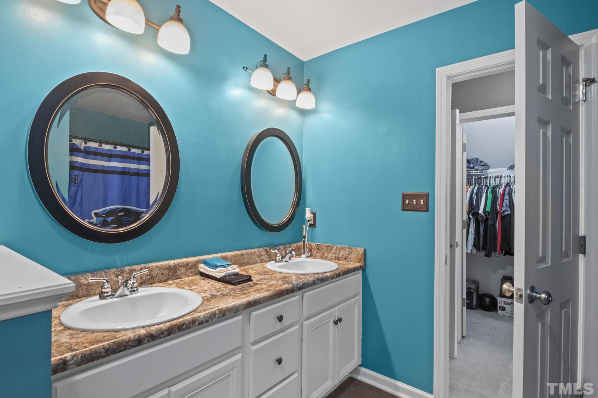 117 Mendel Drive Smithfield, NC 27577 - Photo 27 of 39 a bathroom with a granite countertop toilet a sink and a mirror