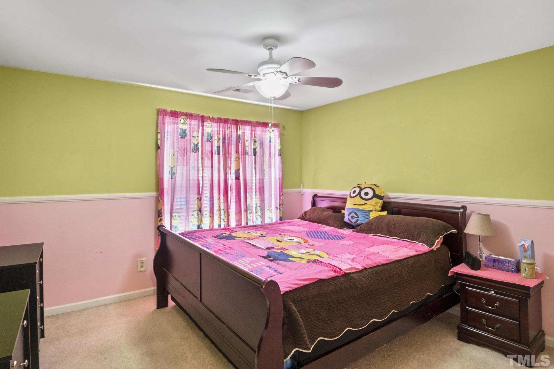 117 Mendel Drive Smithfield, NC 27577 - Photo 32 of 39 a bedroom with a bed and a chandelier