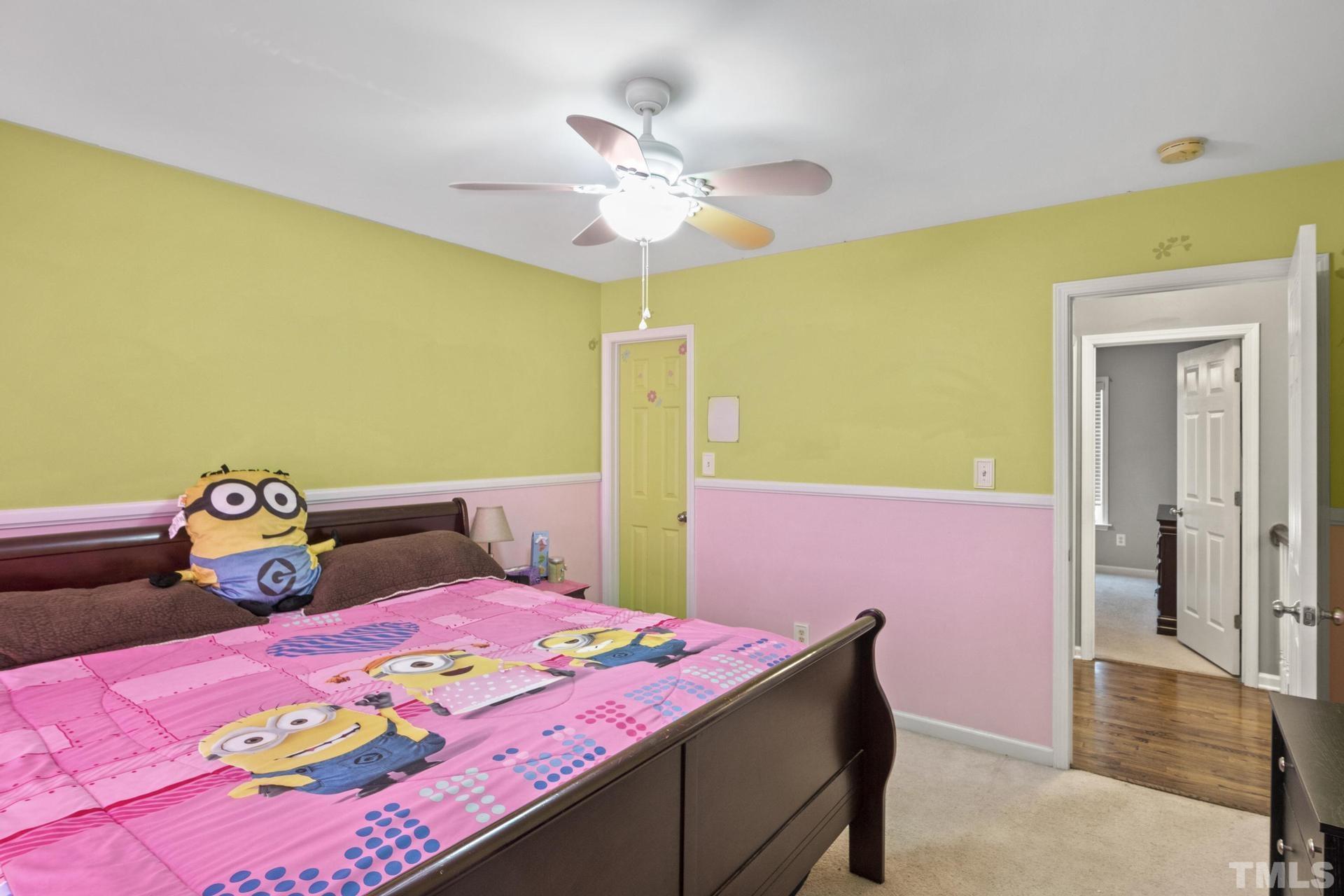 117 Mendel Drive Smithfield, NC 27577 - Photo 33 of 39 a bedroom with a bed and chandelier