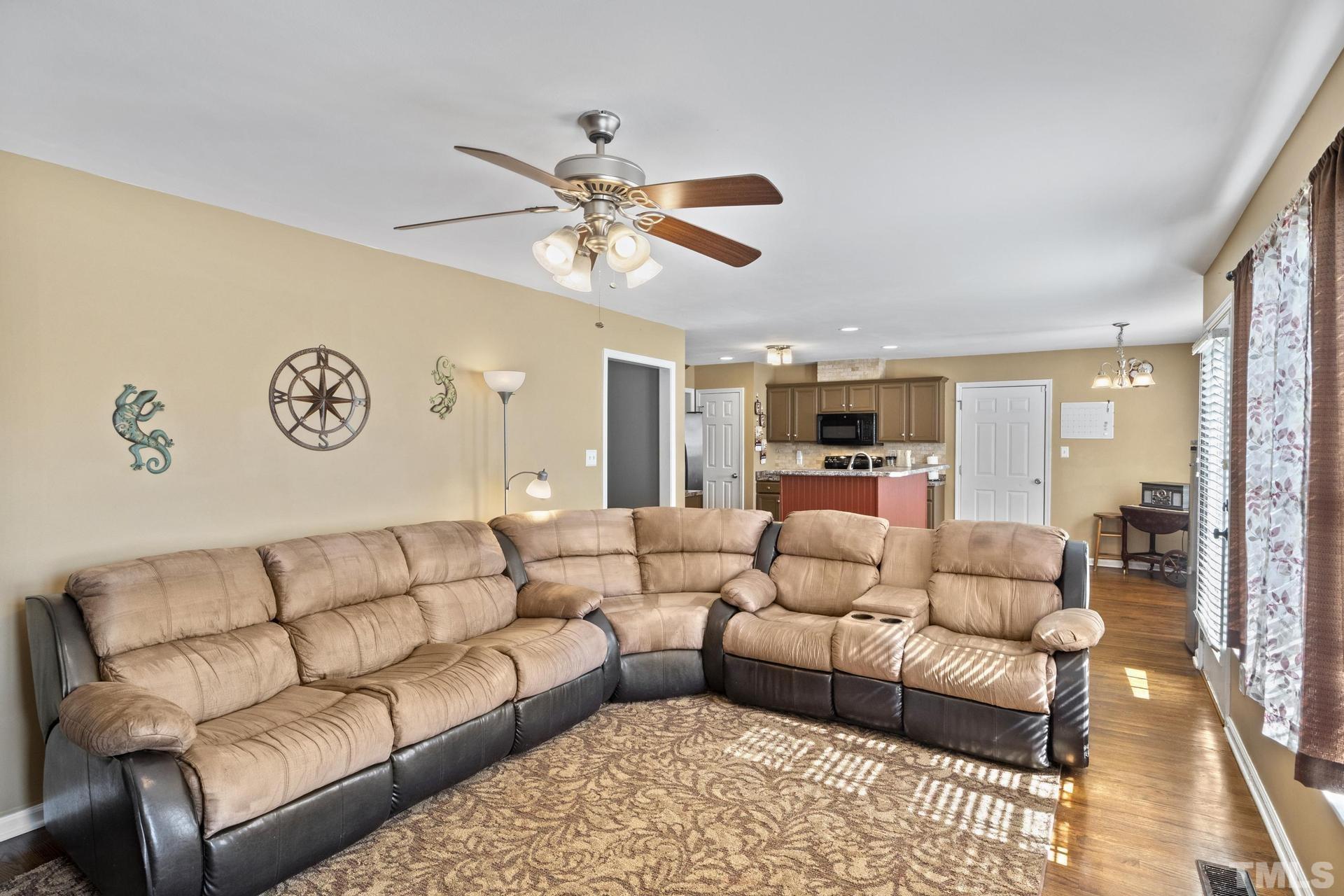 117 Mendel Drive Smithfield, NC 27577 - Photo 9 of 39 a living room with furniture kitchen view and a chandelier