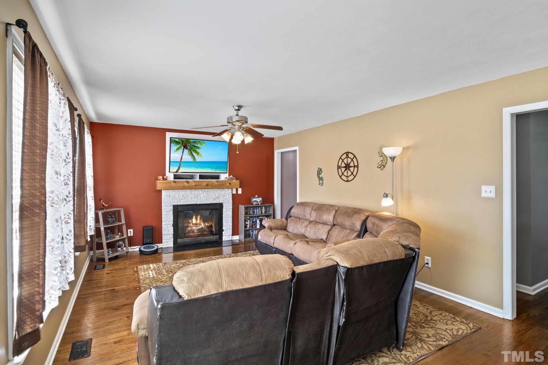 117 Mendel Drive Smithfield, NC 27577 - Photo 10 of 39 a living room with furniture and a fireplace