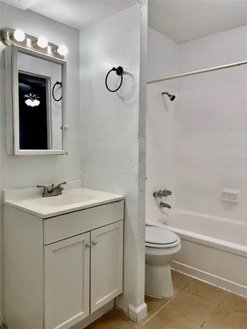 a bathroom with a sink vanity toilet and shower