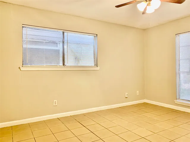 a view of a small space with wooden floor and a chandelier fan