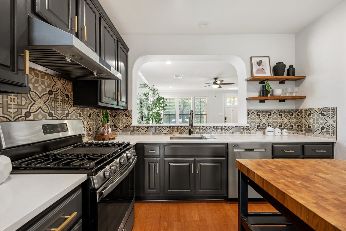 6020 Rutledge Lane Austin, TX 78745 - Photo 22 of 40 a kitchen with stainless steel appliances granite countertop a stove and a sink