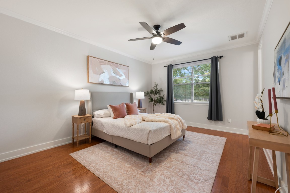 6020 Rutledge Lane Austin, TX 78745 - Photo 28 of 40 a living room with a bed furniture flat screen tv and a large window