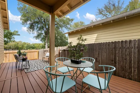 a backyard of a house with table and chairs