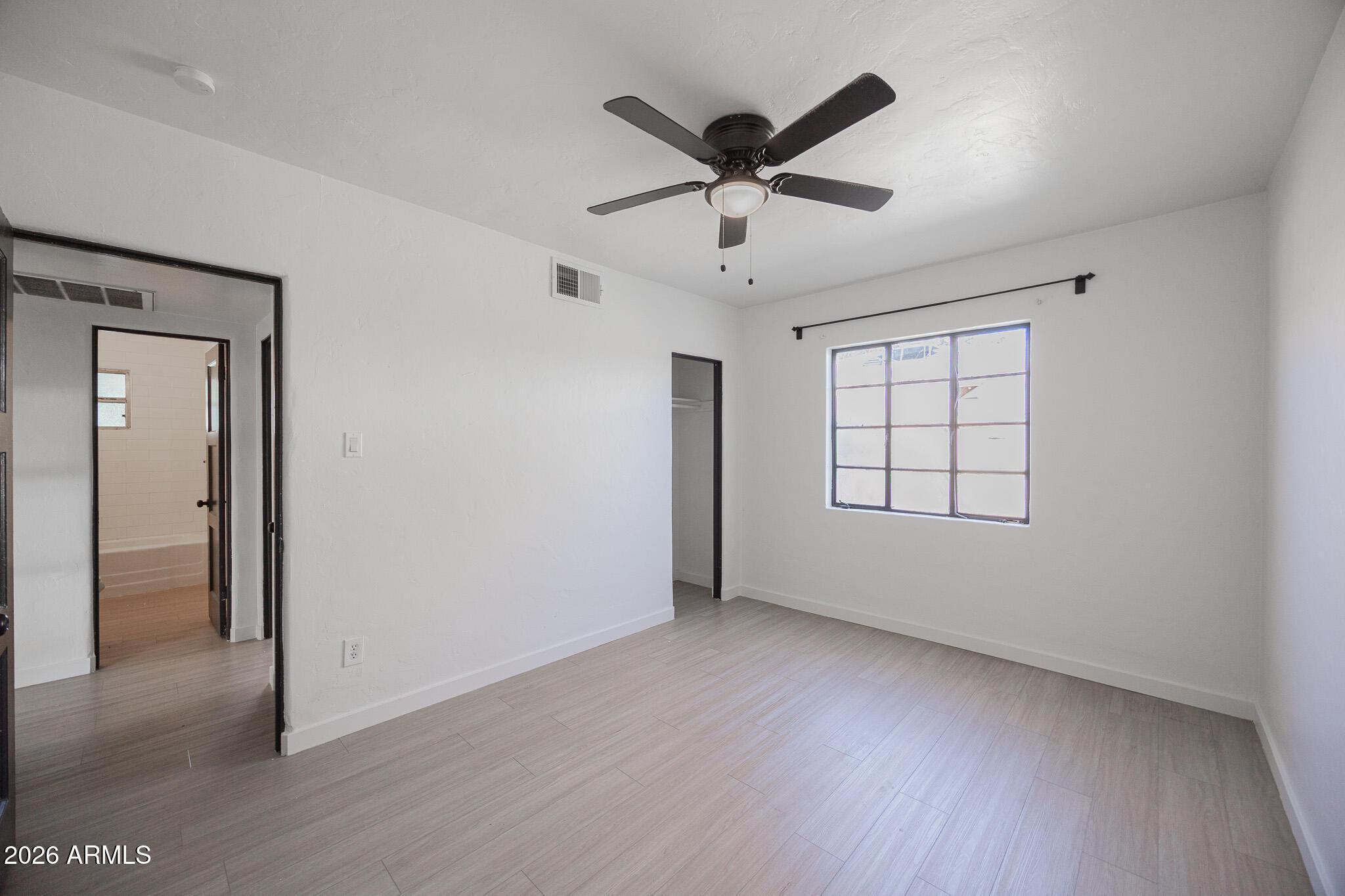 414 West 13th Street Tempe, AZ 85281 - Photo 11 of 21 a view of a big room with wooden floor and windows