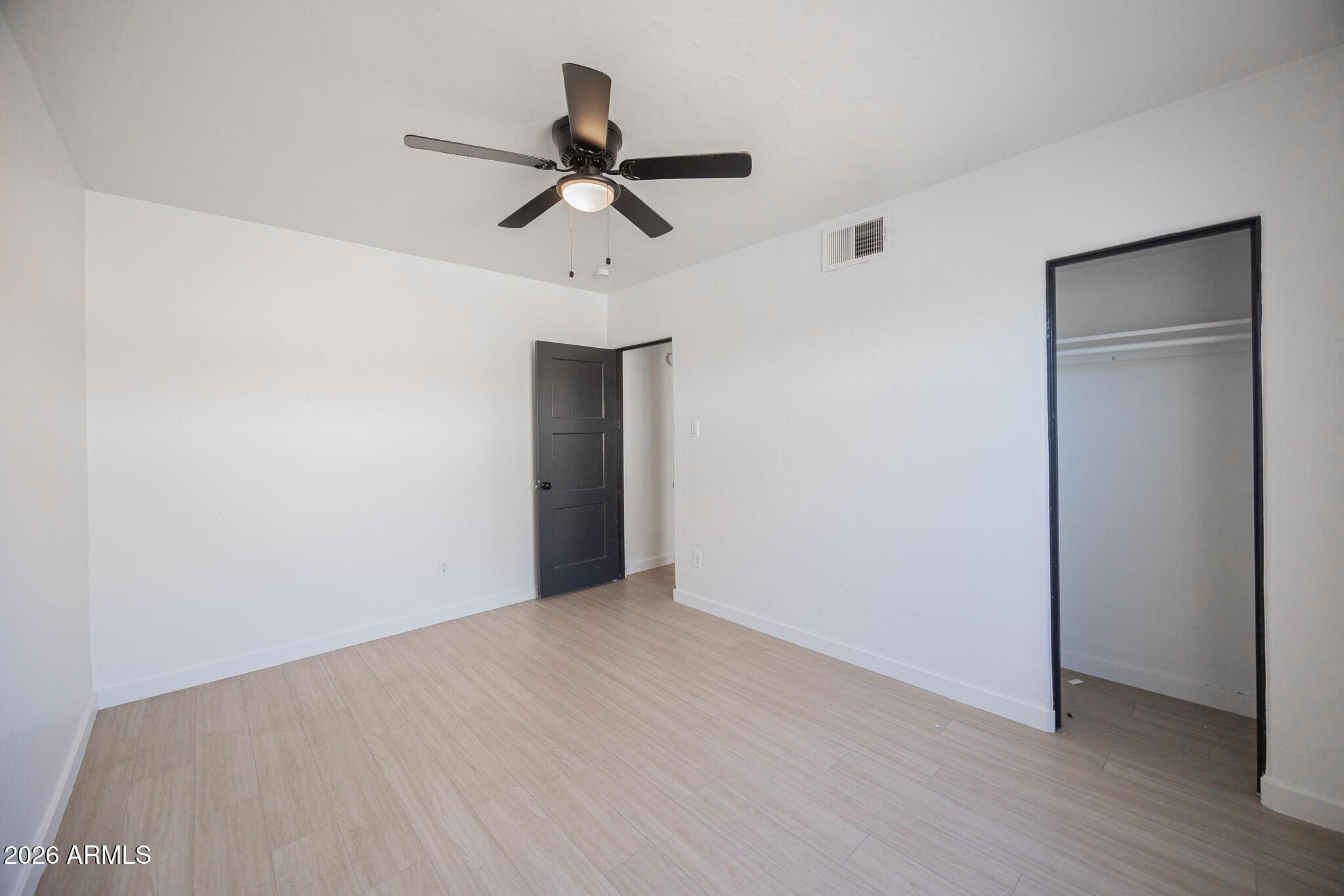 414 West 13th Street Tempe, AZ 85281 - Photo 12 of 21 a view of empty room with wooden floor and ceiling fan