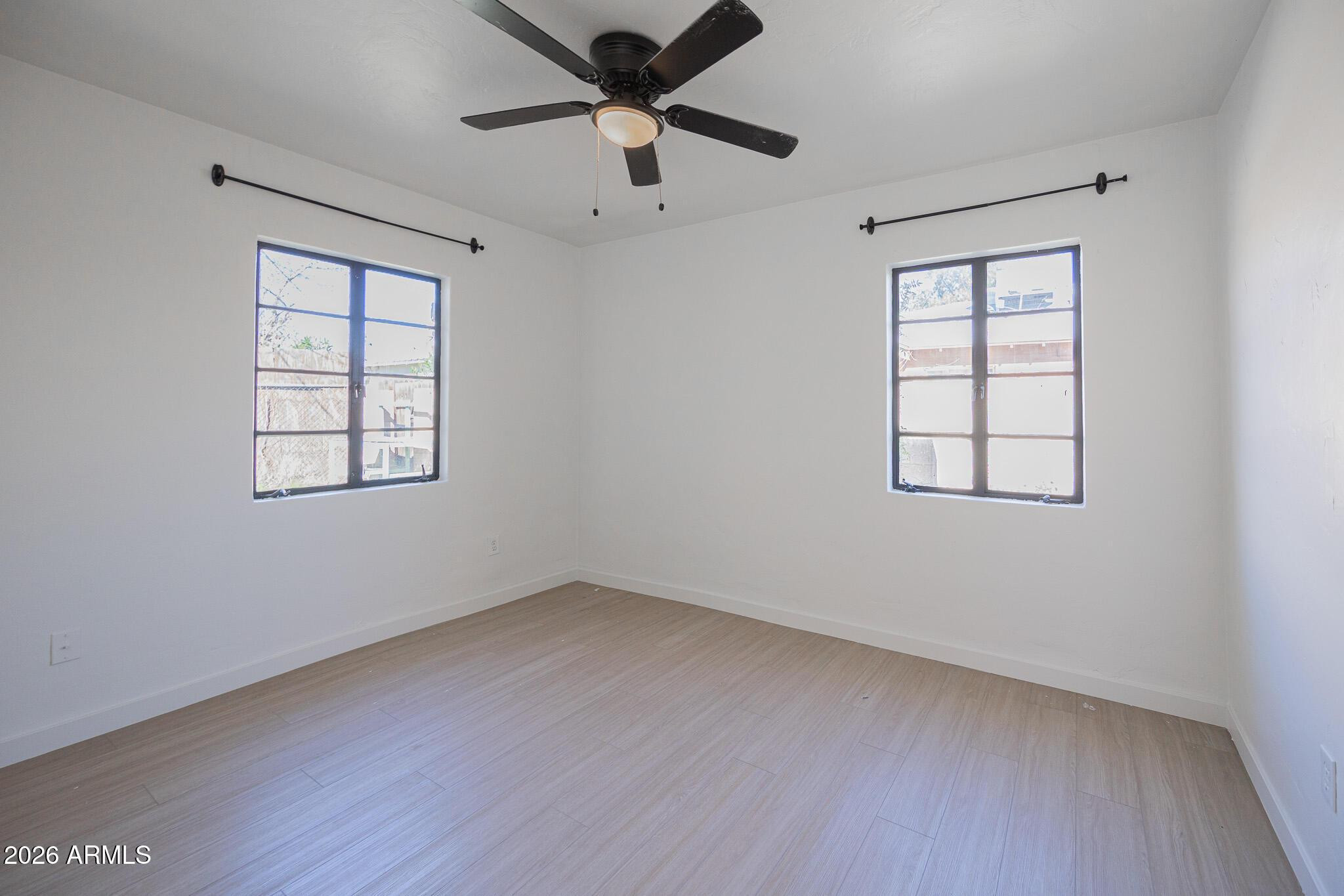 414 West 13th Street Tempe, AZ 85281 - Photo 14 of 21 an empty room with wooden floor ceiling fan and windows