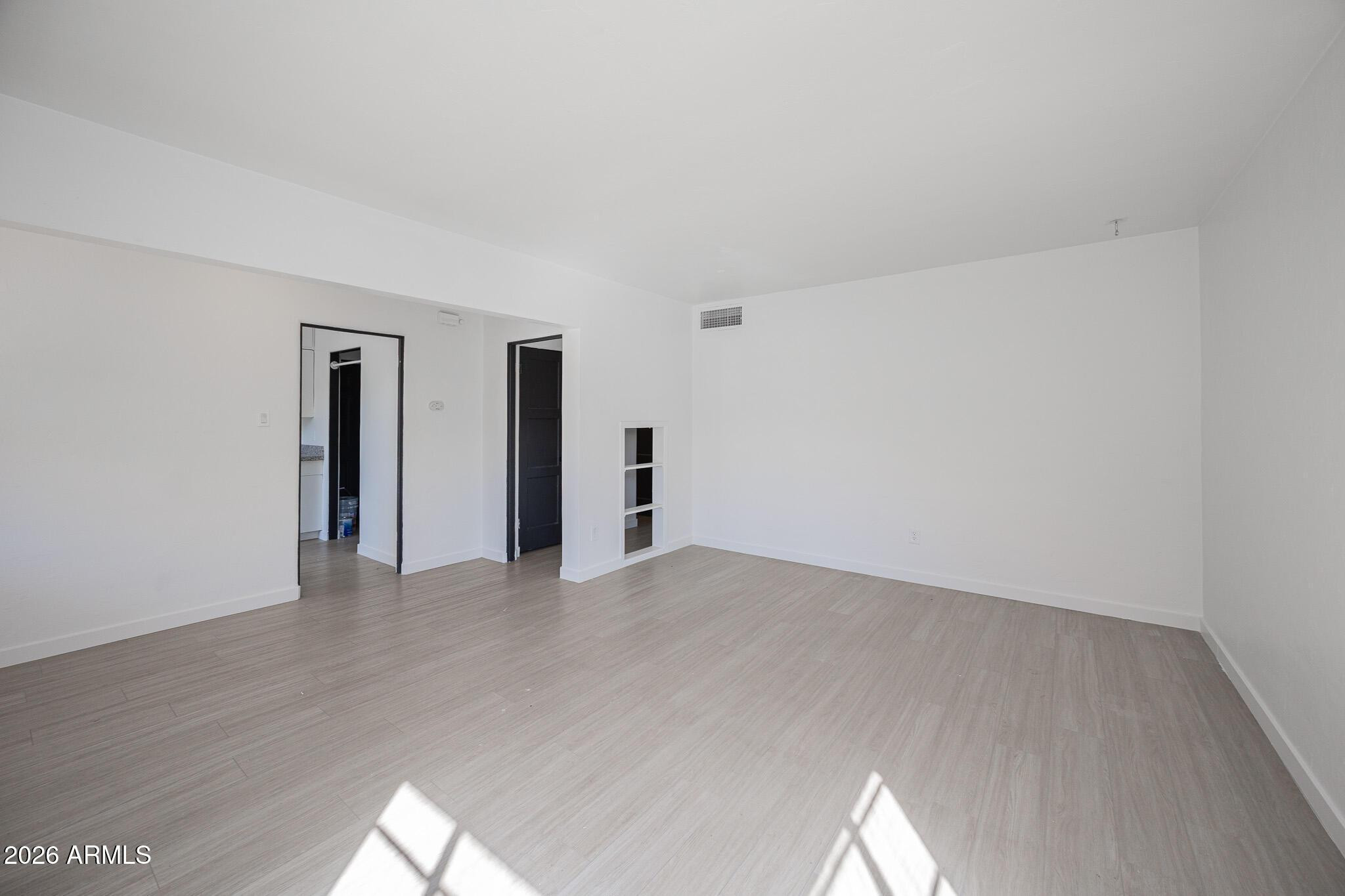 414 West 13th Street Tempe, AZ 85281 - Photo 4 of 21 a view of an empty room with wooden floor