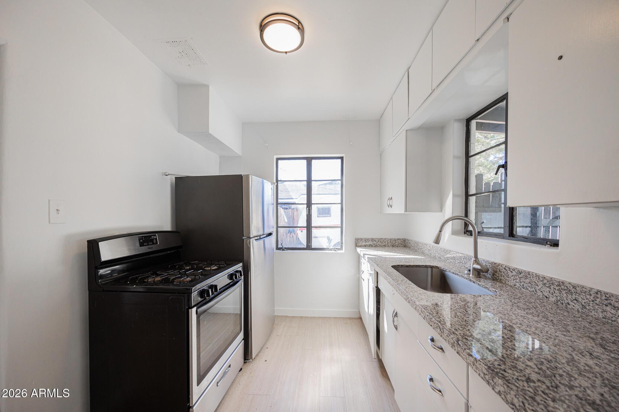 414 West 13th Street Tempe, AZ 85281 - Photo 9 of 21 a kitchen that has a sink and a stove