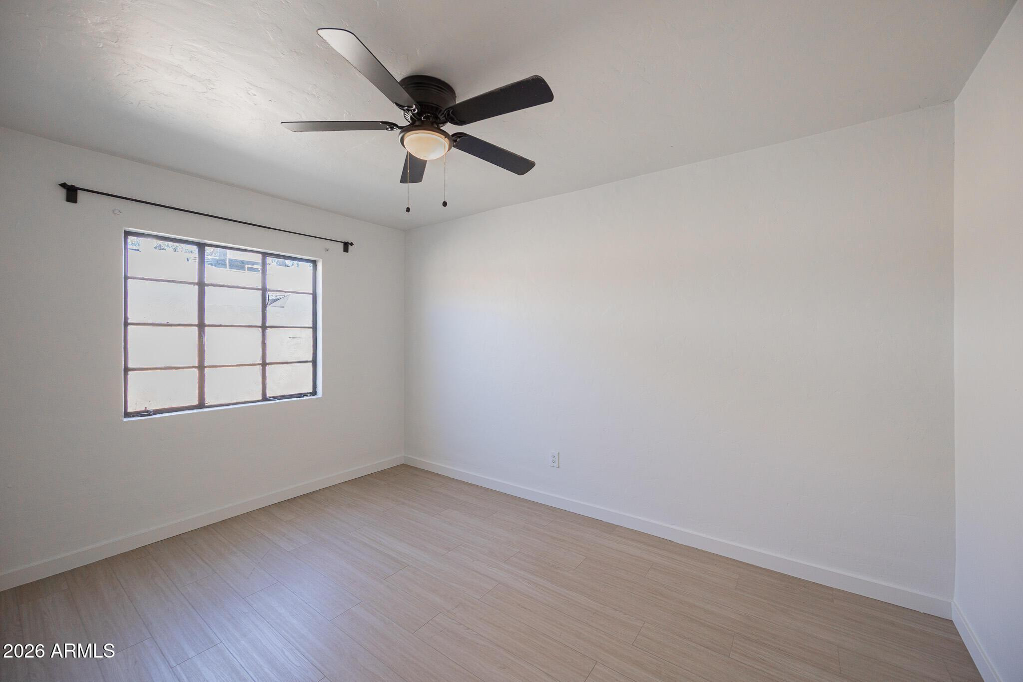 414 West 13th Street Tempe, AZ 85281 - Photo 10 of 21 an empty room with wooden floor fan and windows