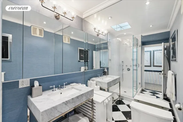 a bathroom with a sink mirror and a shower