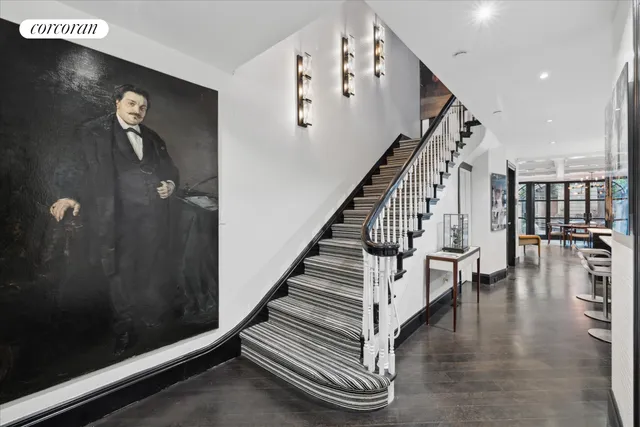 a view of entryway and hall with wooden floor