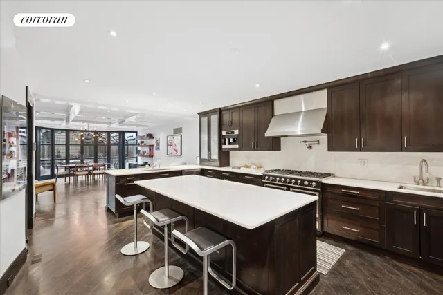 a kitchen that has a table and chairs in it
