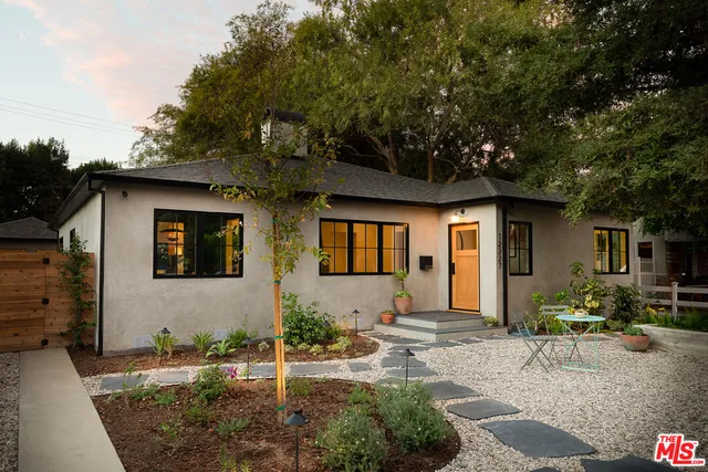 a front view of house with yard outdoor seating and barbeque oven