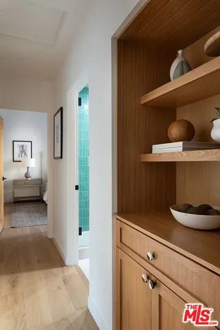 a bedroom with bed and a painting on the wall