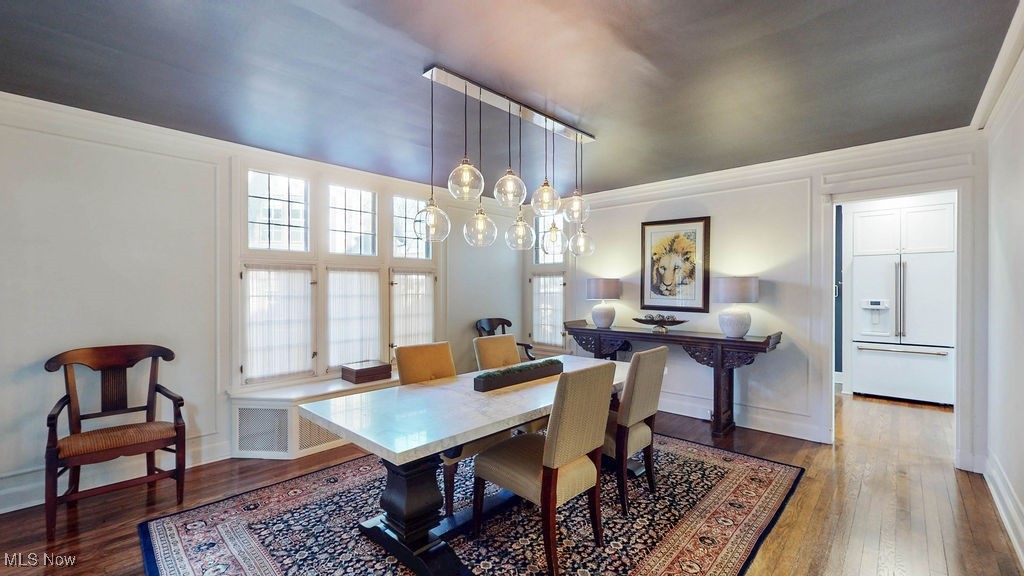 2593 Coventry Road Cleveland, OH 44120 - Photo 11 of 50 Dining room featuring hardwood floors, luxury light fixture and leaded class windows.
