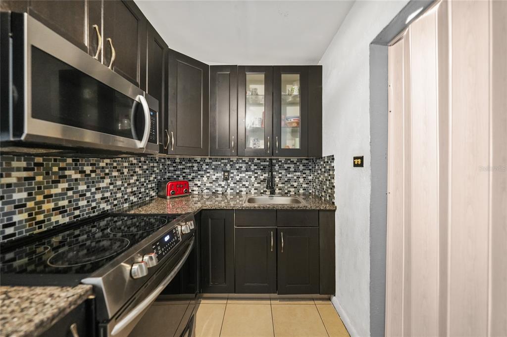 2321 Dallas Street Port Charlotte, FL 33952 - Photo 11 of 38 a kitchen with a stove and a microwave