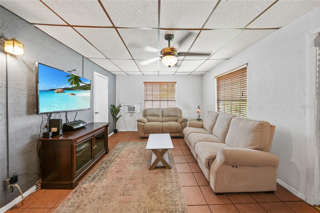 2321 Dallas Street Port Charlotte, FL 33952 - Photo 16 of 38 a living room with furniture a flat screen tv and a window