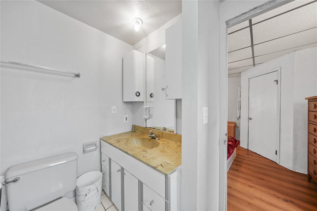 2321 Dallas Street Port Charlotte, FL 33952 - Photo 19 of 38 a bathroom with a granite countertop sink and a toilet