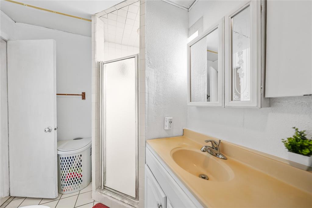 2321 Dallas Street Port Charlotte, FL 33952 - Photo 23 of 38 a bathroom with a granite countertop sink and a mirror