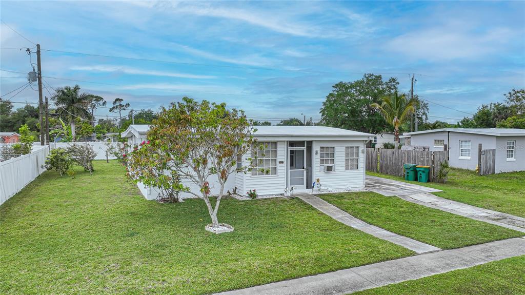 2321 Dallas Street Port Charlotte, FL 33952 - Photo 3 of 38 a front view of a house with a yard